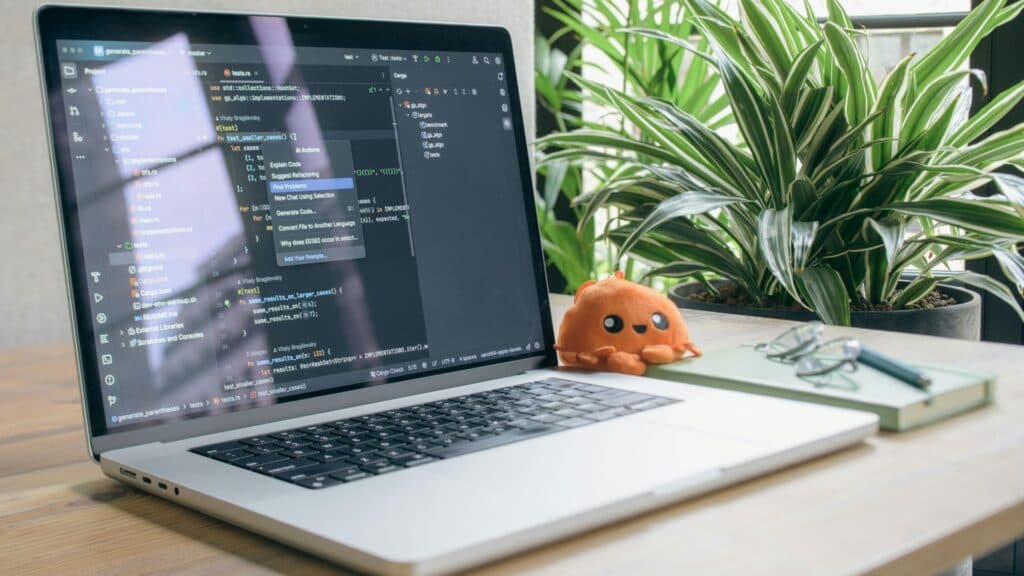 IDE Rust avec suggestions AI Actions sur MacBook illustrant les outils modernes d'une équipe de développement agile