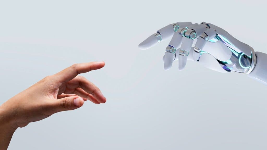 Contact entre une main humaine et une main de robot industriel